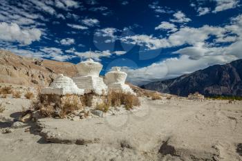 Whitewashed chortens (Tibetan Buddhism stupa) in Himalayas. Nubra valley, Ladakh, India