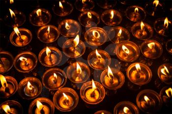 Burning candles in Tibetan Buddhist temple. Himachal Pradesh, India