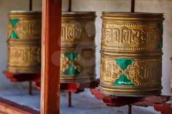 Buddhist prayer wheels in Diskit gompa (Tibetan buddhist monstery). Nubra valley, Ladakh, India