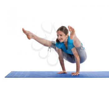 Yoga - young beautiful woman  yoga instructor doing Firefly asana pose (Titibasana) exercise isolated on white background