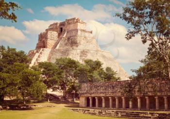 Vintage retro effect filtered hipster style image of anicent mayan pyramid Pyramid of the Magician, Adivino in Uxmal, Merida, Yucatan, Mexico