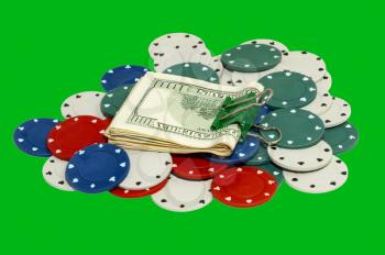 Dollar pack on a casino chips isolated on green background.
