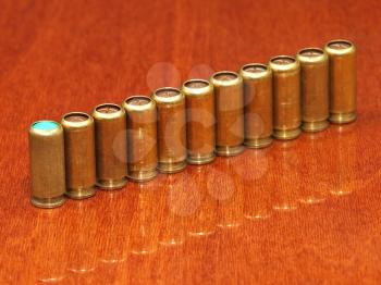 Row of gas  cartridges on a polished table surface.