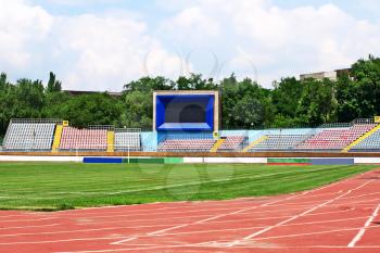 Empty football stadium and scoreboard.