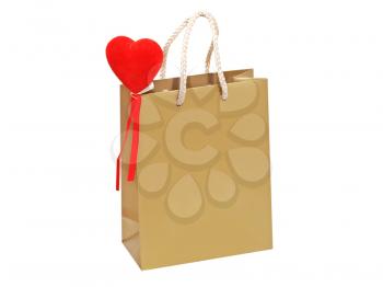 Holiday golden gift bag with red heart isolated on white background.