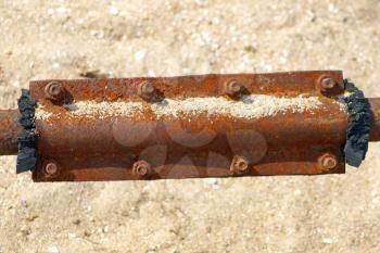 Rusty metal patch on a water pipe.