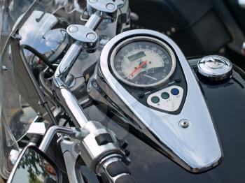 Shine motorcycle speedometer closeup with red needle.