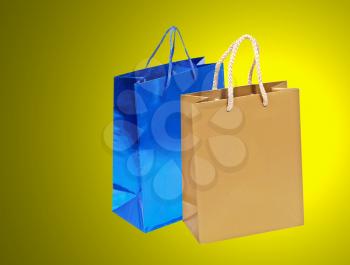 Blue and golden shopping bag on a yellow background.