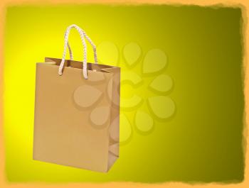 Empty golden shopping bag on yellow background with golden frame border.