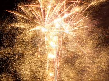 Golden Fireworks Bursts in a Darkness as Abstract Background.