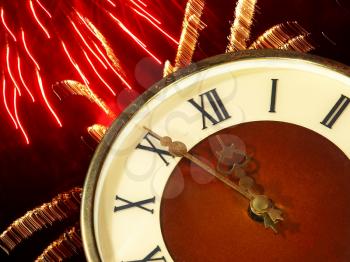 Clock face and bright firework taken closeup.Eve of new year.
