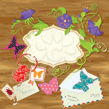 Wooden background with butterflies, beetle, flowers, mail stamps, envelope and empty frame for text. Vintage design