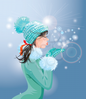 Beautiful brunette girl with warm blue winter hat is blowing snow from her hands (snowflakes in heart shape)
