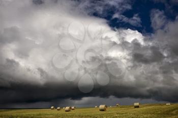Storm Clouds Saskatchewan hay bales in Canada
