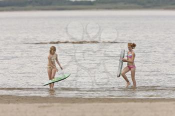 Girls walking along lake shore