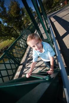 Young boy on bridge in at Wakamow Park