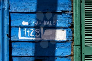 green wood venetian blind and a blue garibaldi wall in la boca buenos aires argentina