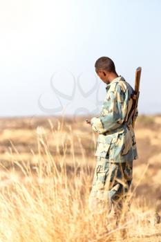  africa  in the land of ethiopia a black soldier  and his gun looking the boarder