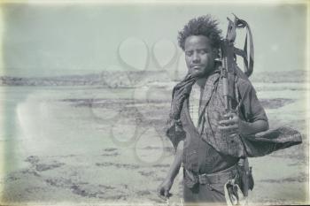 ETHIOPIA,DANAKIL-CIRCA  JANUARY 2018--unidentified irregular soldier looking at the state boarder
