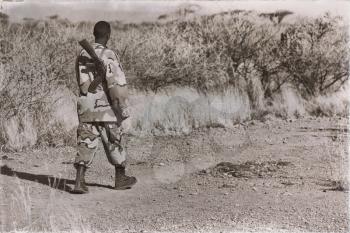  africa  in the land of ethiopia a black soldier and his gun looking the boarder