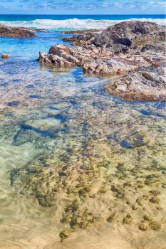 in  australia fraser island the beach near the rocks in the wave of ocean