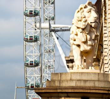 lion  london eye in the spring sky and white clouds