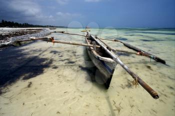 boat beach rope sand and sea in zanzibar coastline