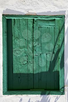 spain green wood   window in a white wall arrecife lanzarote 
