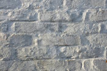 Fragment of an old brick walls painted with lime