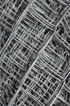 Steel mesh with water drops composed in multiple layers close-up