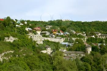 Steep slope near the Smotrych River in the city Kamianets-Podilsky, Ukraine. Modern buildings on the rocks along with remains of medieval fortifications