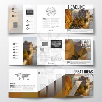 Vector set of tri-fold brochures, square design templates with element of world map and globe. Polygonal background, blurred image, urban landscape, cityscape, modern stylish triangular vector texture