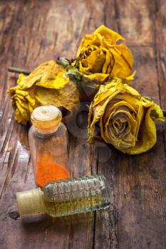 fragrant yellow roses and retro bottle with spirits
