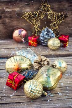 Christmas ornaments and pine cones on wooden background.Photo tinted.Superimposed texture.