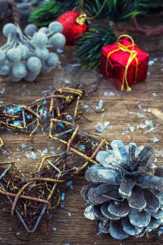 Christmas ornaments and pine cones on wooden background.Photo tinted.Superimposed texture.