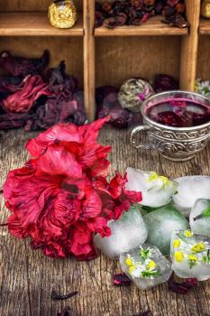 Hibiscus tea rose and welding on the background of the tea shelves in vintage style.Photo tinted.Selective focus