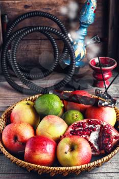 Stylish Smoking hookah and basket with apples,pomegranate and lime