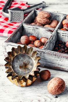 kitchen table with baking dish and a box with walnuts and hazelnuts