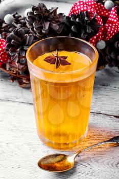 pumpkin jelly drink with anise in the background with wreath of fir cones in autumn