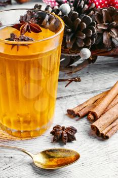 pumpkin jelly drink with anise in the background with wreath of fir cones in autumn