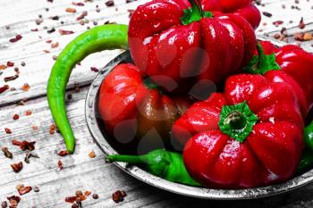 Set of red pepper and paprika on iron plate with bright light background with spices
