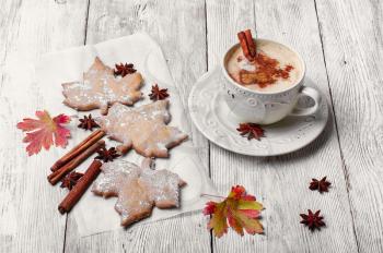 Cookies in the shape of maple autumn leaf and and coffee