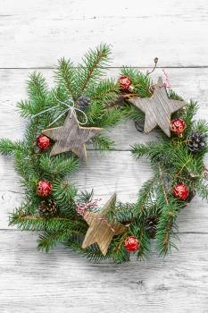 Noel wreath of fir branches decorated with Christmas star toys