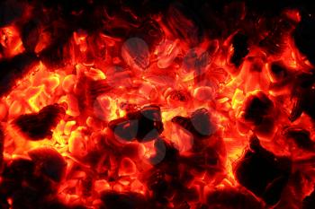 Ash fire in dark night. Campfire coals burn in the darkness. Ejection lava