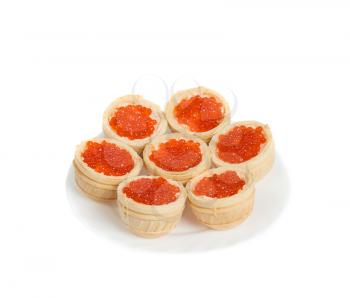 Red caviar in tartlets on plate, isolated on white background, high depth of field, studio shot