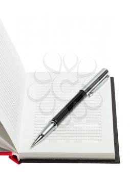 Part of opened notepad with pen isolated on white background, studio shot