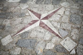 Ancient mosaic stone pavement with wind rose pattern