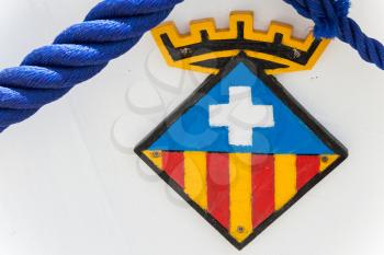 Calafell, Spain - August 13, 2014: Calafell town Coat of arms on the bow of white fishing boat,  Catalonia, Tarragona region, Spain