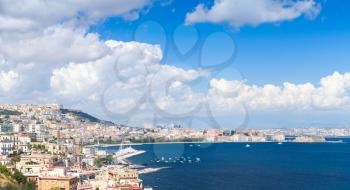 Gulf of Naples panoramic landscape with cityscape under blue cloudy sky