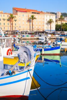 Small colorful wooden fishing boats moored in old port of Ajaccio, Corsica, France